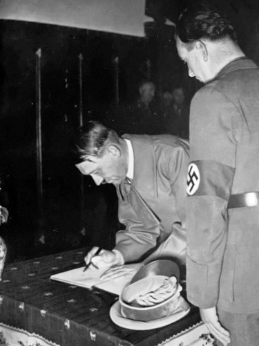 Adolf Hitler signs the Eger city book